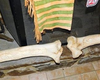 These are elephant leg bones with scrimshaw scenes of elephants. 
