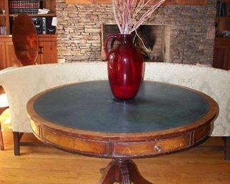 leather top game table and large red glass jar