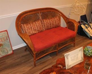 Woven wicker loveseat w/ cushion and 2 pillows