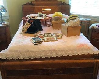 Queen deco bed littered with vintage pill-box hats and sundry