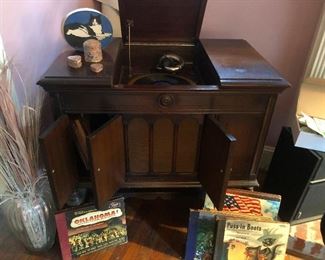 Pretty cabinets underneath open up and spill the LPs!