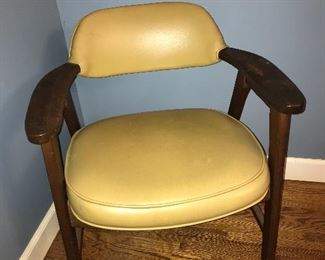 Vintage wood chair with vinyl seat and back.