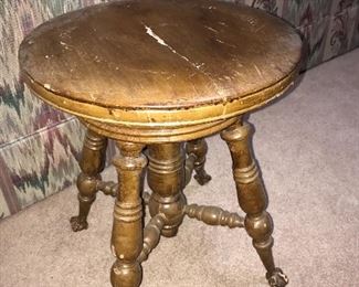 Antique organ/piano stool with glass ball and claw feet.