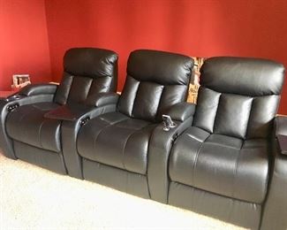 Set of three black leather recliner theatre seats