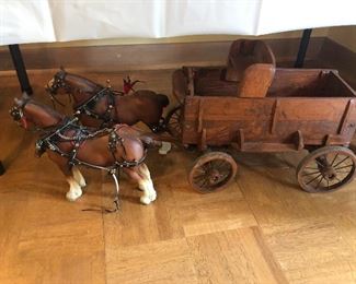 Two Clydesdale horses with wooden wagon.