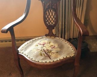 Carved chair with needlepoint seat.