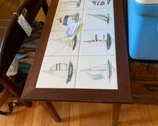 #6 tile top coffee table with sail boats on top 16x34x17 $75.00
