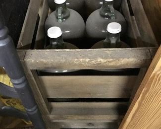 Glass jugs in wooden crates