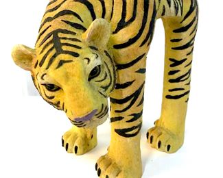 Stool is hand painted.  Contains painted and  relief detail to mimic fur. Pedestal, stool,  footrest, Tiger stool, Animal Stool. Piece  appears to possibly be wooden. Measures  approx 11 inches tall 12 inches long 7 inches  wide.