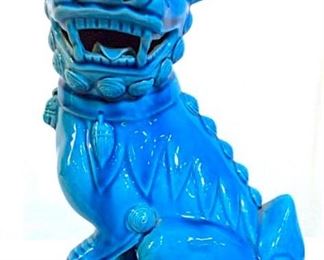 Piece has tones of plum and light cerulean. Piece depicts a Seated Temple Lion.