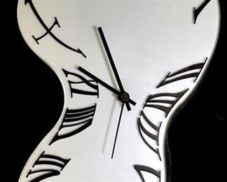 1970s Arti & Mestieri Design Salvador Dali inspired ‘melting’ Melting Clock. Marked for Art & Mestieri Design on glass face. Features a frosted glass face in freeform shape with black metal rim, second, minute and hour hands with 'melting' Roman Numerals. Pendulum needs reaffixing to clock. Battery powered, not tested, Hermle Quartz 2200 Made in Germany. Measures approx 14.5 inches in height by 9.5 inches in width by 1.25 inches in depth.