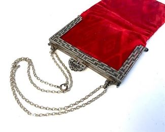 Victorian Style wristlet purse with marcasite, rhinestone encrusted clasp frame and closure with chain strap. Vibrant red velvet pouch. Measures approx 8.5 inches in height by 4.4 inches in width. Drop strap of chain measures approx 6 inches in length. Some rhinestones might be missing. Interior lace lining has minor wear.