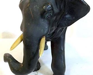 Elephant sculpture is black toned. Piece is  possibly bronze. Piece appears to contain  carved bone. One Tusk Of Figural needs  repair. Piece has evident wear. Measures  approx 10 inches tall 14 inches deep, 6 inches wide. Contains some cracks. asian arts  and crafts, animal statuary, home accent,  decorative arts, asian arts, home decor 