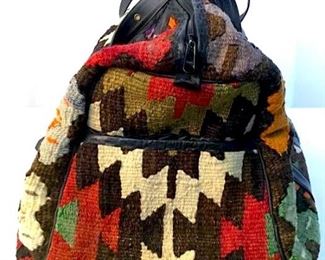 Kilim Style tapestry duffel bag. Label on  interior reads JOAN DAVID. Piece contains  tones of red, cream, brown, orange, & green.  Piece measures approx 21 inches long 13  inches deep, 24 inches tall. kilim tapestry duffel, geometric design, duffel carry all  bag  