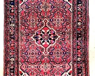 Rug is wool and handmade.  Contains multi  toned floral and geometric detail with tones  of navy, red, cream, brown, green, & pink.  Piece measures approx 54 inches long 40  inches wide.  rug, carpet arts and crafts, decorative arts and design, home decor,  interior design, geometric design 