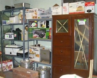 VINTAGE WARDROBE CLOSET AND SHELVES OF ALL KINDS OF KITCHEN APPLIANCES AND CABELA FOOD PROCESSORS, NOTICE THE LARGE CAMP POTS NEVER USED