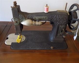 White sewing machine in nice cabinet