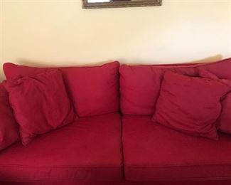Nice red couch that would go great with any neutral painted room. 
