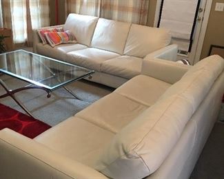 2 white Macy’s Natuzzi Edition white leather Couches
Red floor lamp by Crate & Barrels
Glass/chrome coffee table