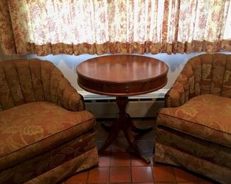 matching set of cushioned chairs, wooden end table with drawer, toile fabric curtains
