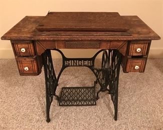 Vintage Singer sewing machine in cabinet, and table.  31” x 36” x 17”