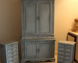 Aqua colored armoire style entertainment cabinet and matching night stands. 