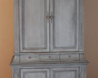 Aqua colored armoire style entertainment cabinet. 