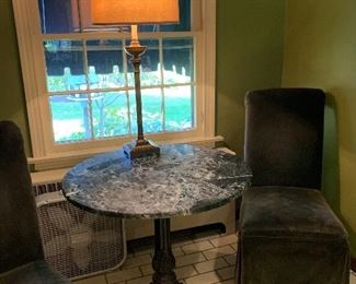 Vintage marble top bistro table w ornate feet.