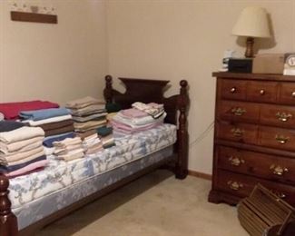 Cannonball headboard twin bed frame; highboy dresser; bedding and assorted linens 