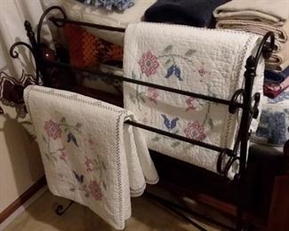 Hand embroidered quilted bed covers; quilt or blanket rack