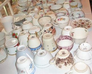 Large assortment of odd cups and saucers
