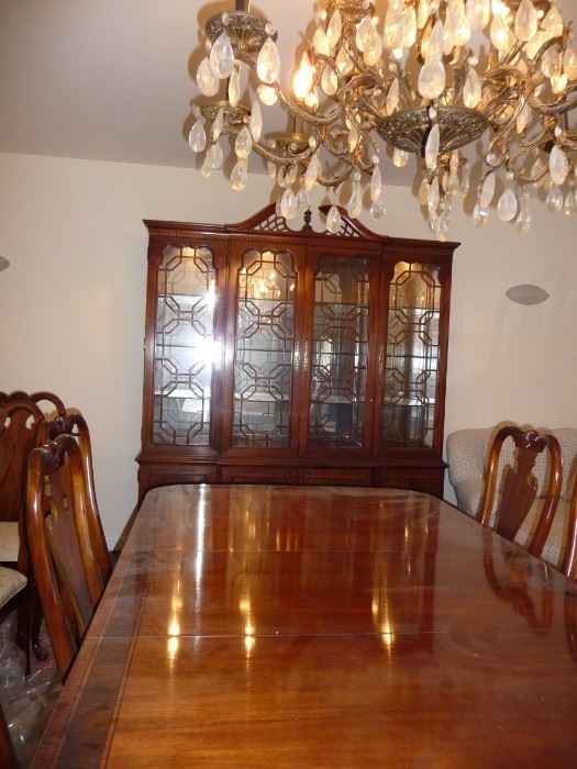 Thomasville dining set includes table with leaves, custom pads, 12 chairs, and china cabinet.