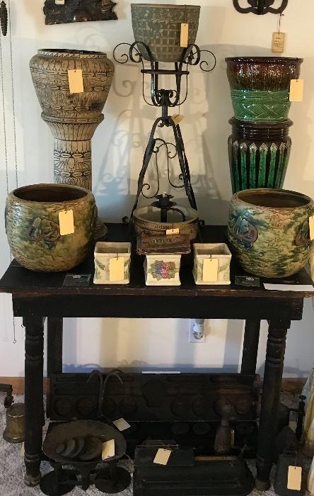 American Art Pottery Collection ~ Weller Majolica Jardiniere And Pedestal. Monmouth Stoneware Egyptian Revival Jardiniere And Pedestal, Roseville  Imperial Jardinieres ~ Two Available, Roseville Roma & Roma Cameo Planters, Brush Planter With Rose And Ivy Pattern, Old Wrought Iron Plant Stand, Old Weather Black Painted Wooden Table