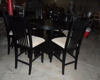 Sorry the picture is dark, round Pub table with 6 chairs and a leaf.