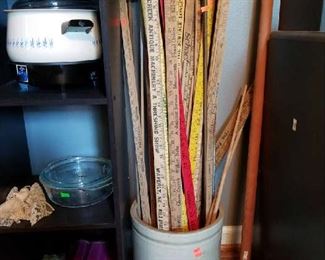 Antique yard sticks in an old crock