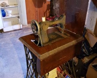 Antique Singer Treadle Sewing Machine Table with wrought iron stand.
