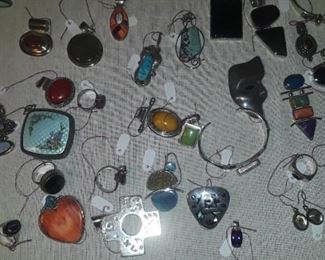 Lots of semi precious stone and sterling silver pendants , large pieces including Navaho. 