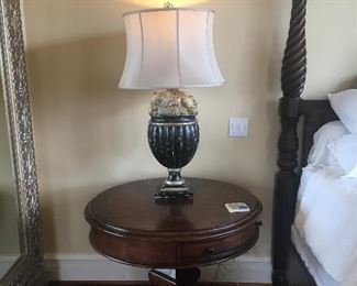 Round side table by Stanley shown with one of a pair of table lamps