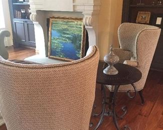 Pair of custom upholstered chairs shown with round side table