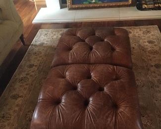 Pair of tufted leather ottomans