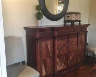 Buffet/sideboard, also makes an excellent bar. Shown with round beveled mirror, decorative chest and topiary