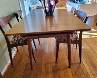 1950's Hans J. Wegner table and chairs are in excellent 70 year old condition! They have been reupholstered which you can redo as well!