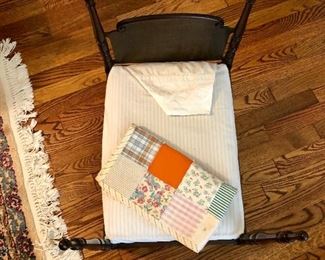 Vintage wooden cradle with quilt