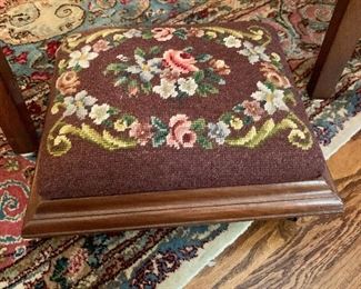Needlepoint foot rest with casters