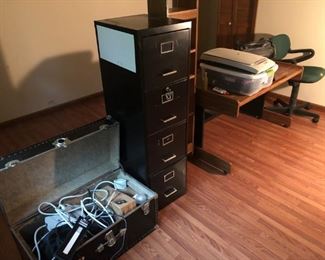 Office desk, file cabinet, wires, chair