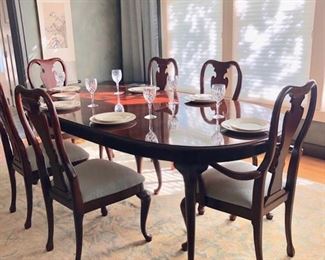 Thomasville dining table with two inserts and six chairs.