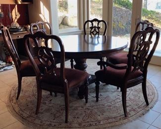 7-foot round table with 6 chairs and 1 insert