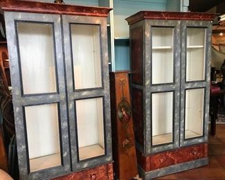 Faux painted cabinets/shelves with chicken wire in doors.