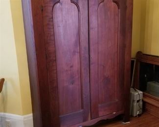 Antique Walnut Wardrobe.  One interior side has shelves, the other side is for hanging items.  This one does not break down.