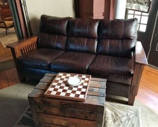 Genuine Leather Sofa with Craftsman style detailing in oak. Very gently used to watch others playing pool in the Sun Room. This is not antique but is a convincing reproduction of a Craftsman piece - and less age. (The trunk is not being sold.)